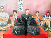 Front view of a pair of black Nike basketball shoes with textured uppers and speckled soles.