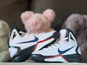 Close view of both shoes showing the navy Swooshes, white uppers and red midsole accents