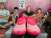 Front view of bright pink Nike basketball shoes with layered uppers and pink laces.