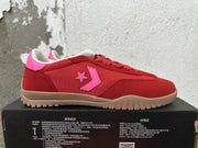 Side view showing the red and pink upper, star-and-chevron motif, and tan-colored sole.