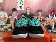 Front view showing black toe panels, teal laces and white outsoles