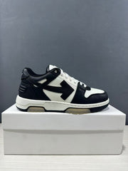 Clean side profile of one black-and-white low-top sneaker displayed on a shoebox.
