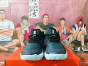 Front view of blue Nike sneakers with black laces and pale aqua outsole details.