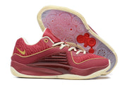 Burgundy Nike KD 16 shoes with cream and gold-colored details and a patterned outsole.