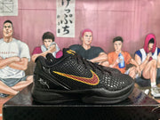 Side view of a black Nike basketball sneaker with a raised textured upper and red-and-yellow Swoosh design.