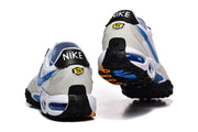 Rear and outsole view of Nike Air Max Plus sneakers with black heel tabs and blue outsole accents.