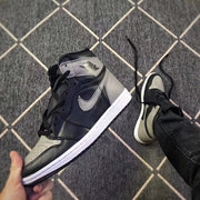 Angled front-side view showing the grey Swoosh, black overlays, perforated toe box and high-top collar.