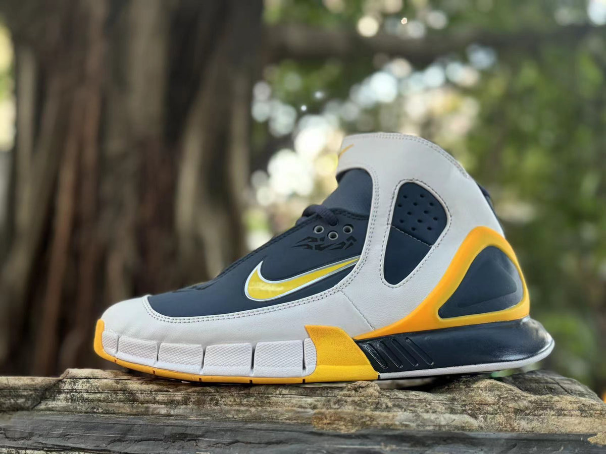 Side view of navy, white, and yellow Nike Kobe 2K5 high-top basketball shoe