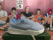 Side profile of a blue and gray low-top sneaker showing the textured side panel, layered upper, and thick off-white sole.