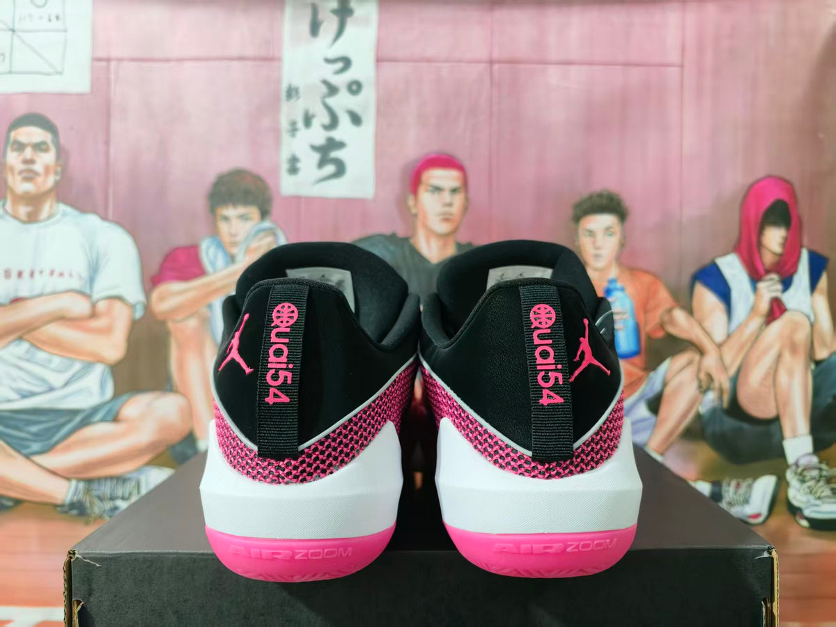 Rear view of black and pink Jordan basketball sneakers showing the heel branding and pink outsole.