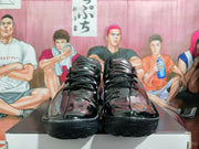 Front view of black lace-up basketball shoes with Nike Swooshes