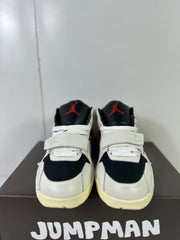 Front view of the pair showing black toe panels, white laces, forefoot straps, and red tongue branding.