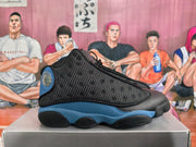 Side view of a black and blue Jordan sneaker showing its dotted panel and rounded outsole