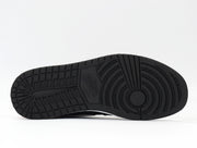 Close-up of the black outsole with segmented tread and circular forefoot traction pattern