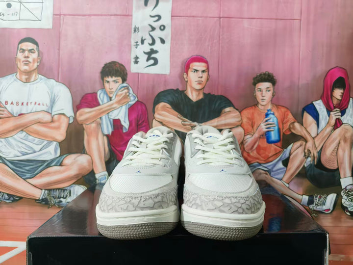 Front view of grey and white Jordan basketball sneakers displayed on a shoebox.