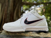 Side view of a white Nike Kobe 4 shoe with a black and red Swoosh
