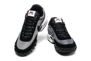Front view of a pair of black and grey lace-up sneakers.