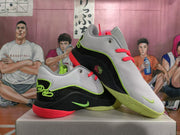 Pair of Nike basketball shoes showing perforated uppers and contrasting green and coral-red details