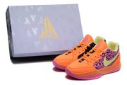 Jordan sneakers displayed beside a branded box, showing the orange, pink, black, and lime color scheme.