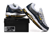 Nike Air Max 97 OG sneakers in white, navy, and yellow displayed on a shoe box; box label shows a sample size.