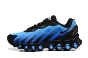 Side view of a blue and black Nike Air Max DN8 sneaker with rounded cushioning units along the sole.