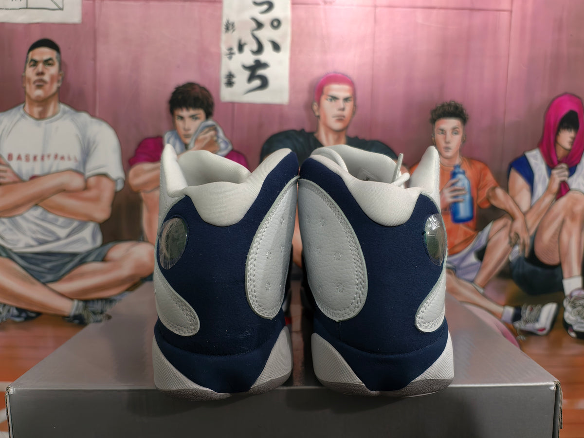 Rear view of white, grey, and navy Jordan basketball shoes with translucent heel details.