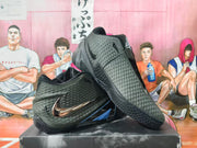 Side view of black and silver Nike basketball shoes with metallic-look Swoosh