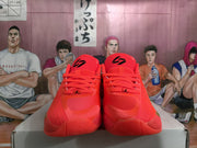 Front view of the red basketball sneakers showing laces, black tongue branding, and textured toe areas.