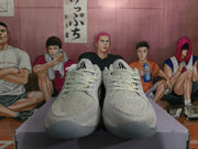 Front view of white speckled Nike sneakers with white laces, padded tongues, and translucent blue-gray toe outsoles.