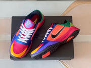 Top and side views of the pair showing the tongue logos and color blocking