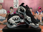 Angled view of the camouflage-style sneakers showing the padded collar, black laces, red accents, and translucent outsoles.