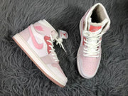 Top-down view showing the perforated pink toe boxes and lace arrangement.