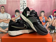 Pair of black Nike basketball shoes, one shown at an angle, with green accents and speckled midsoles.