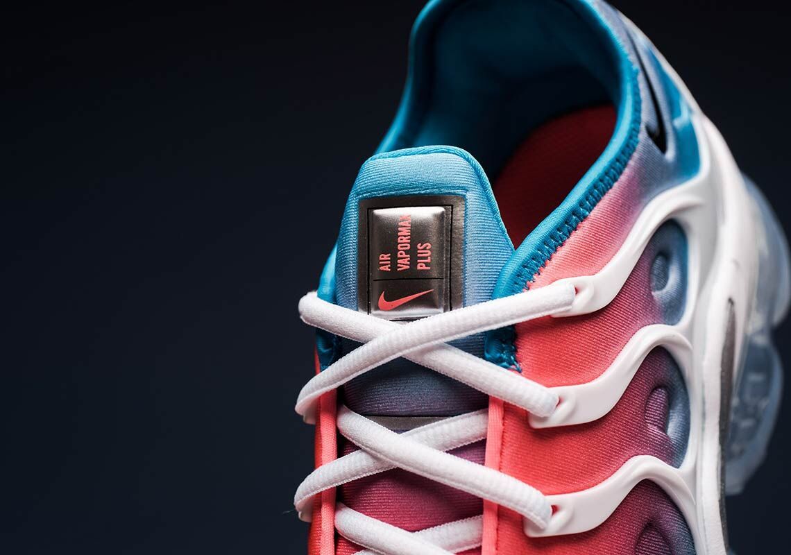 Close-up of the Nike Air VaporMax Plus tongue, white laces, and pink-and-blue upper