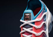 Close-up of the Nike Air VaporMax Plus tongue, white laces, and pink-and-blue upper