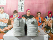 Rear view of grey Nike sneakers showing heel panels and pull tabs.