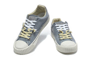 Pair of blue-gray low-top sneakers with white and pale yellow laces