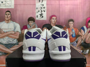 Rear view of white and purple Nike Kobe basketball shoes showing heel details.