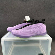 Pair of purple Nike basketball shoes with black collars and textured side panels