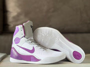Angled view showing the shoe upper and white outsole with circular traction details.