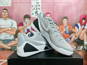 Angled view of the pair highlighting the gray perforated uppers, white Swooshes, black accents, and white soles.
