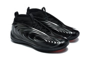 Three-quarter view of the black lace-up sneakers with glossy sculpted side panels and red outsole accents.
