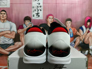 Rear view showing textured white heel panels, red collar accents, black heel sections, and signature-style red detailing.