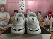 Rear view of the Nike sneakers showing padded collars, heel construction, and black-and-white detailing.