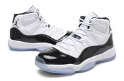 Angled product view showing the high-top silhouette, white upper, glossy black overlays, and translucent soles.