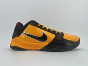 Side profile of the orange-and-black shoe showing the Swoosh, black forefoot overlay, and orange midsole.