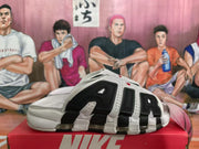 Side view highlighting the large black AIR lettering, white panels and transparent midsole cushioning.