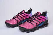 Pair of pink Nike sneakers with black laces and blue side accents.