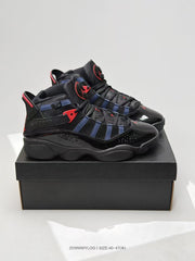 Pair of black, navy, and red high-top sneakers displayed on a black shoebox.