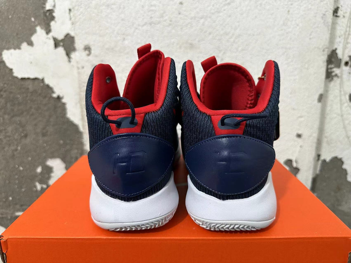 Rear view of navy and red high-top Nike basketball shoes with white soles